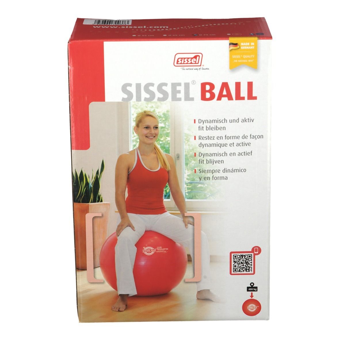 Boîte Sissel Ball rouge. Femme assise sur le ballon. Inscription: Sissel Ball.