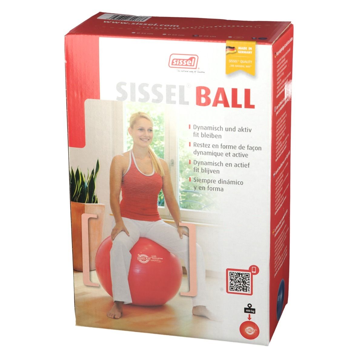 Boîte Sissel Ball rouge. Femme assise sur le ballon. Inscription: Sissel Ball.