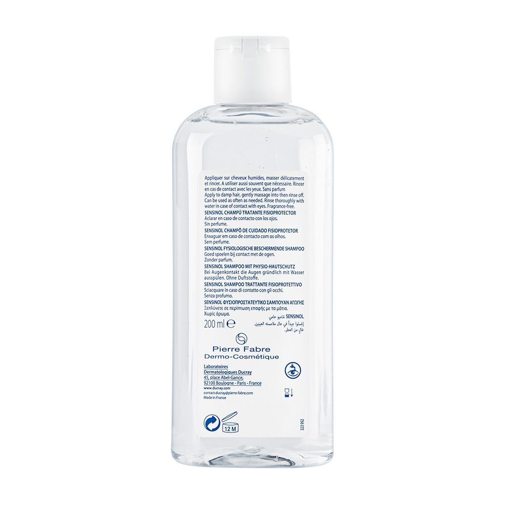 Achterkant van de shampoo fles. Tekst: SENSINOL, DUCRAY. 200 ml. Gebruiksinformatie.
