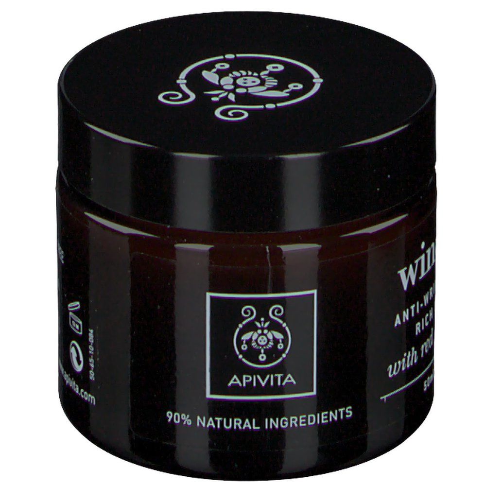 Donkerbruine pot met zwarte deksel. Opschrift: Apivita, 90% natuurlijke ingrediënten. Wine Elixir Anti-Wrinkle & Firming Rich Face Cream.