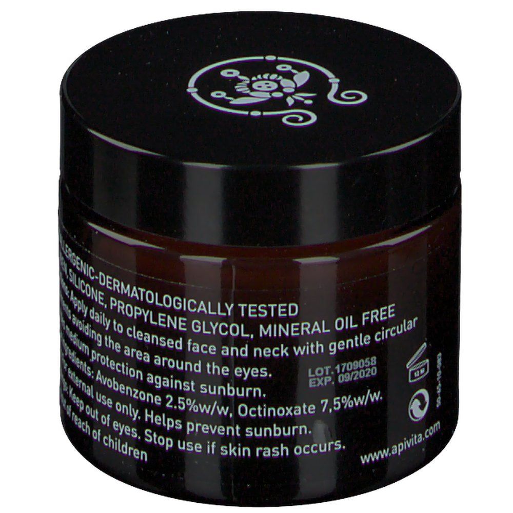 Crème brune en pot de verre avec couvercle noir. Inscription : wine elixir. Texte avec ingrédients et instructions d'utilisation.