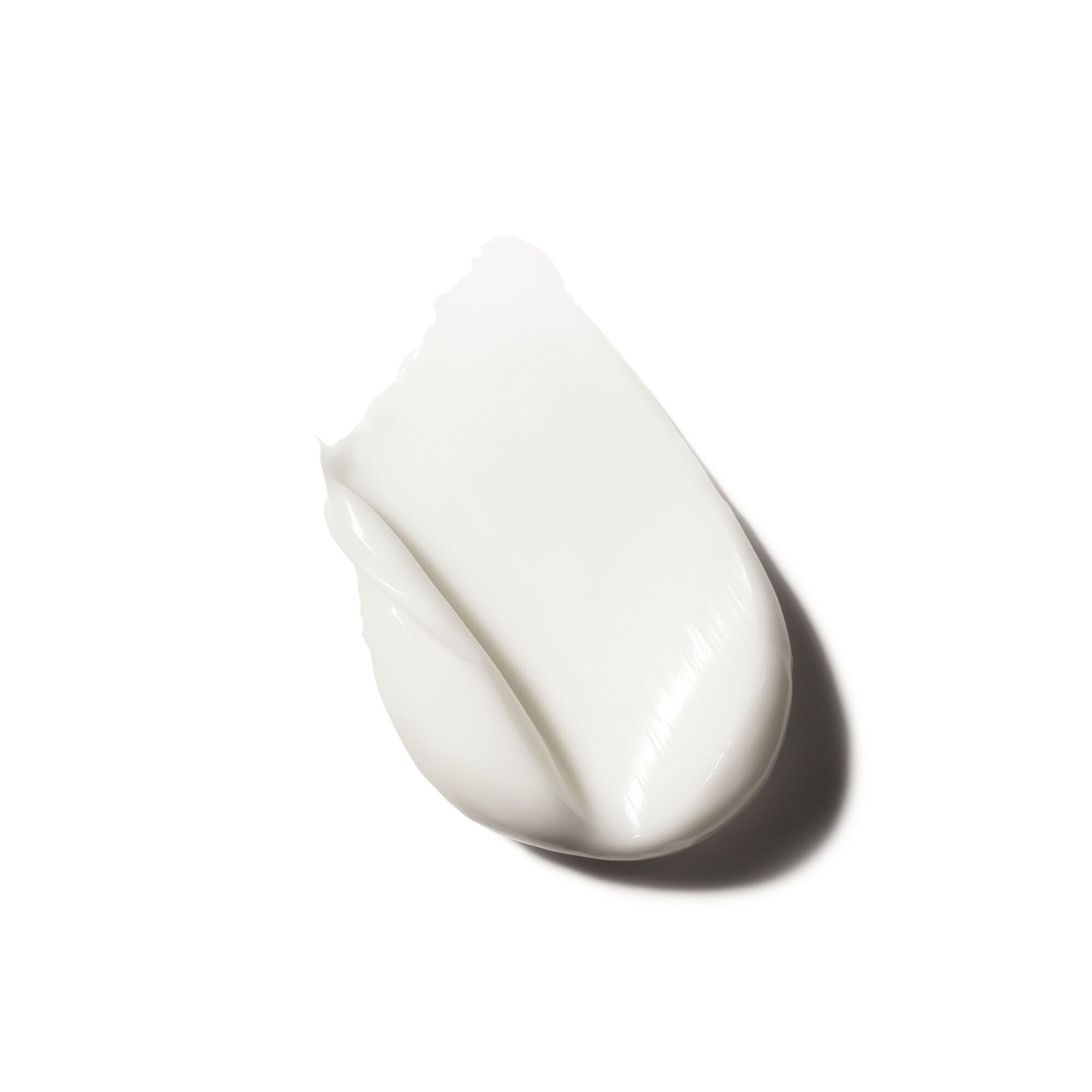 Witte crèmevlek. Gladde textuur. Op witte achtergrond.