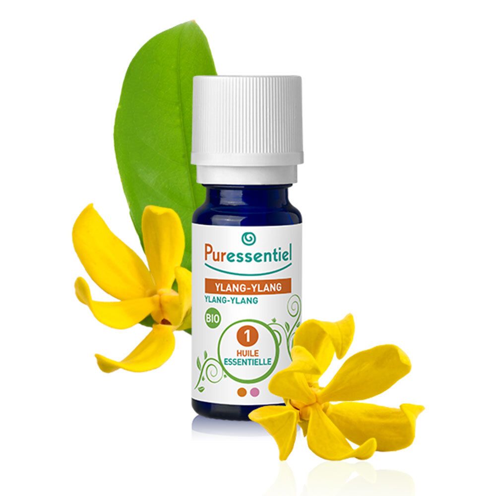 Bruine glazen fles met witte dop. Gele bloemen en groen blad naast de fles.