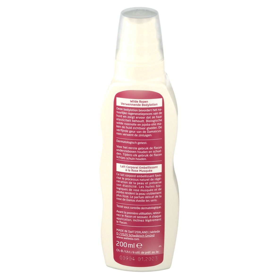 Flacon de lotion corporelle Weleda. Vue arrière. Récipient blanc avec étiquette rose. Texte et ingrédients. Tête de pulvérisation transparente.