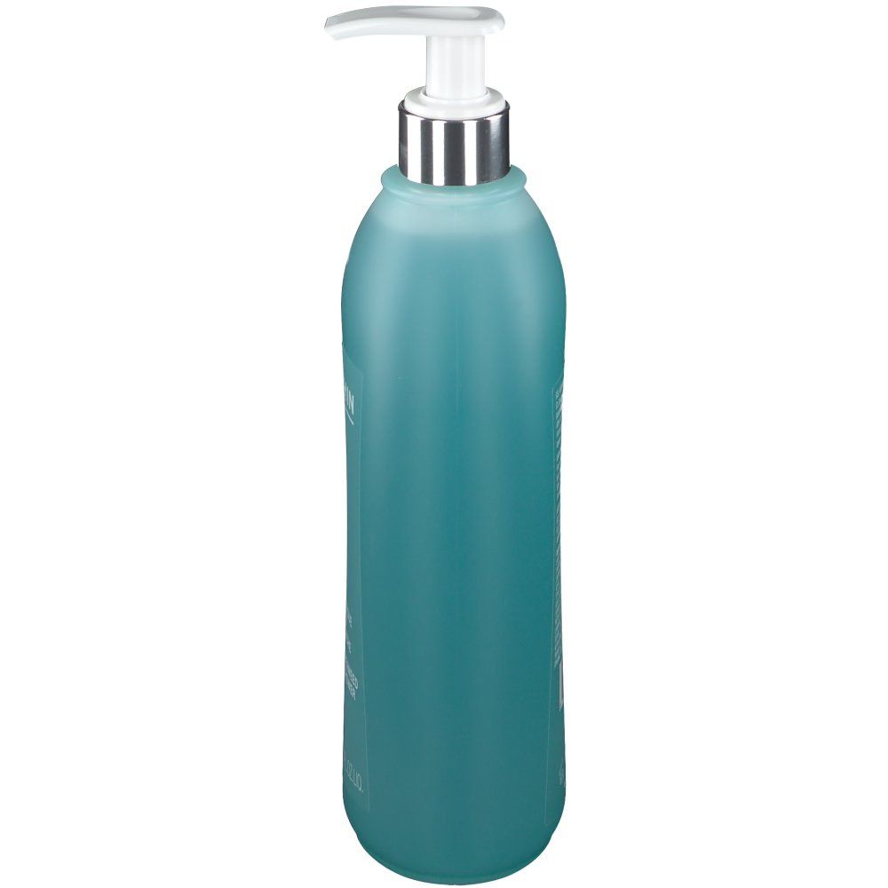 Flacon turquoise avec pompe. Forme cylindrique. Tête de pompe argentée. Nom du produit illisible.