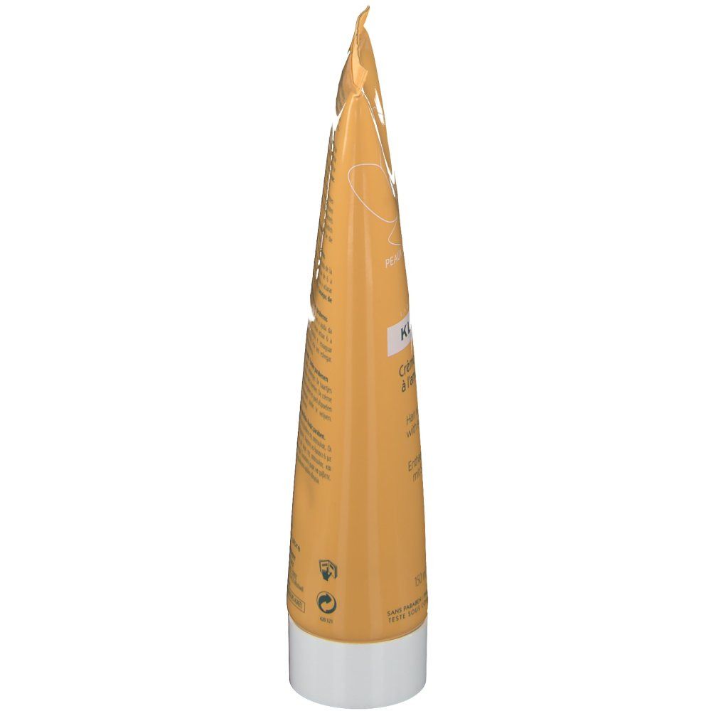 Côté du tube de crème dépilatoire KLORANE. Tube jaune avec bouchon blanc. Texte et symboles de recyclage.