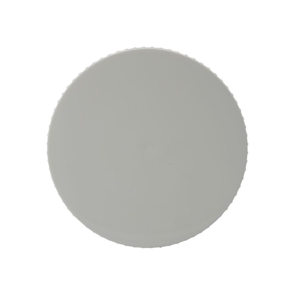 Vue de dessus d'un couvercle blanc. Surface cannelée.