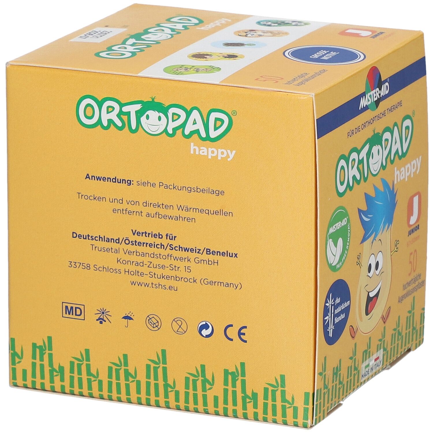 Boîte jaune avec impression. Impression : Ortopad happy, Master-Aid, marquage CE. Texte en allemand.