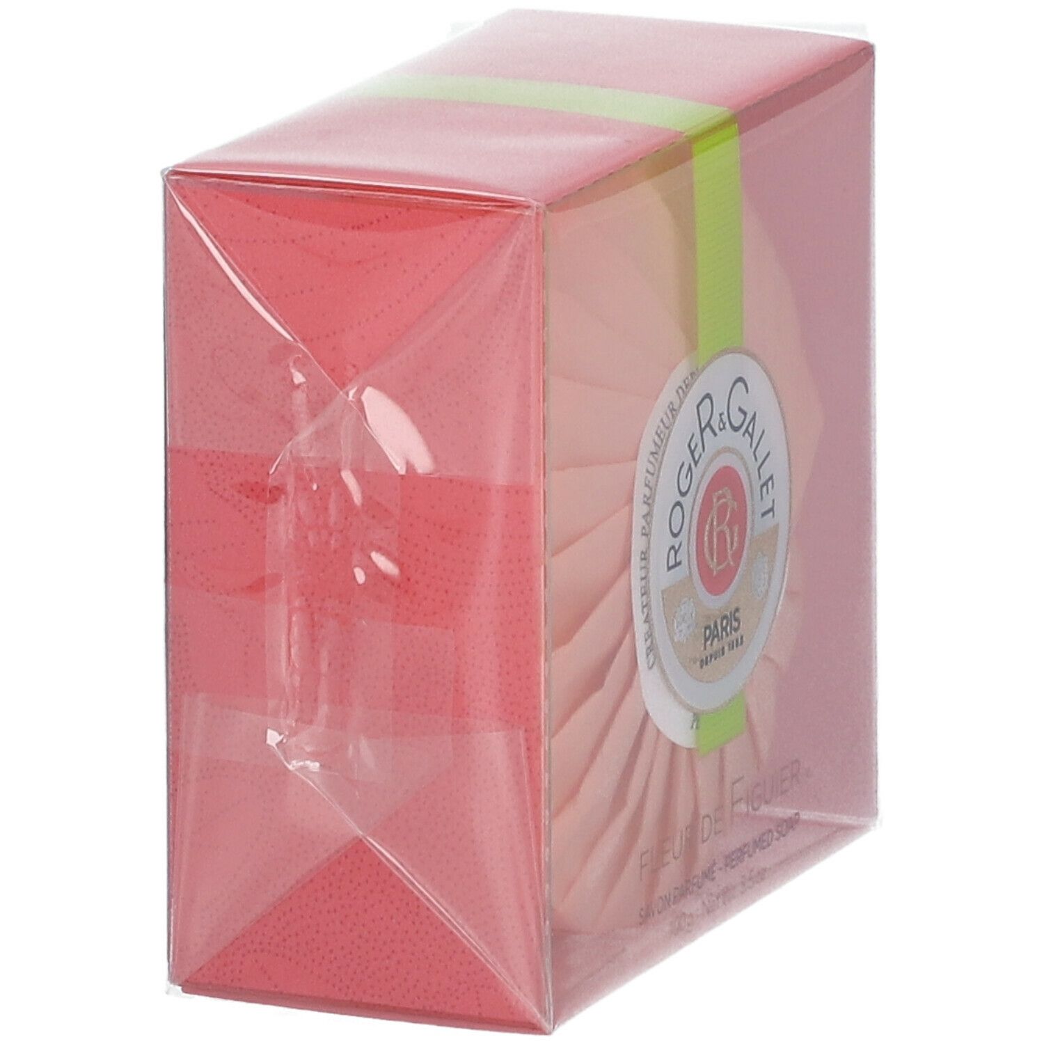 Emballage du savon rond. Boîte rose avec enveloppe transparente. Ruban vert. Savon partiellement visible.
