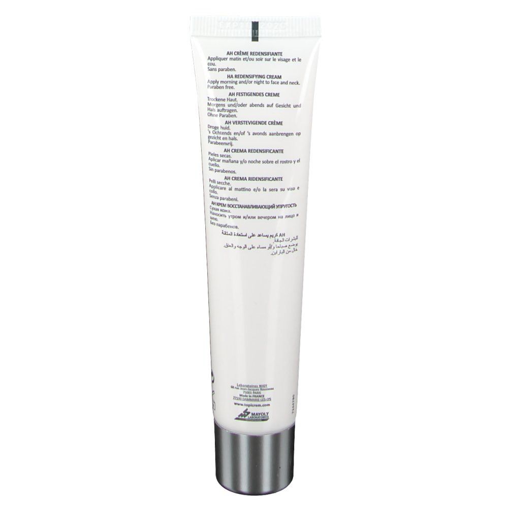 Dos du tube blanc. Texte en plusieurs langues. Bouchon argenté. Informations sur le produit.