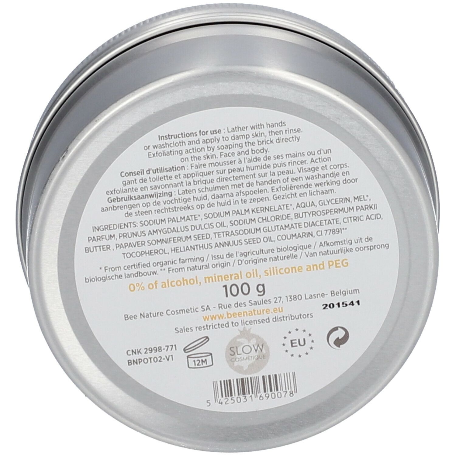 Savon rond avec points noirs. Dessus: logo. Couleur blanc-beige.