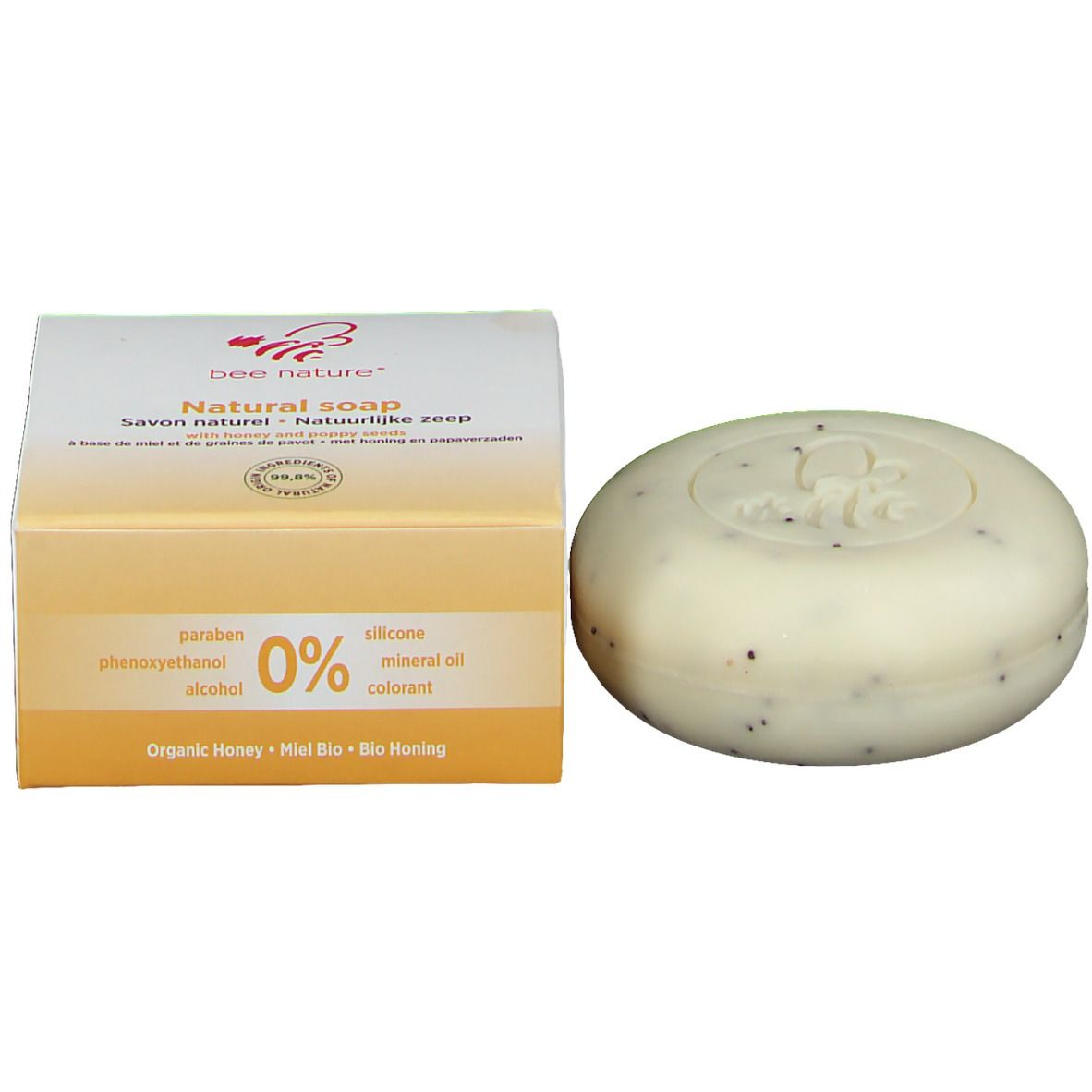 Savon et emballage. Emballage: bee nature® Natural soap. Savon: rond, blanc-beige, points noirs.