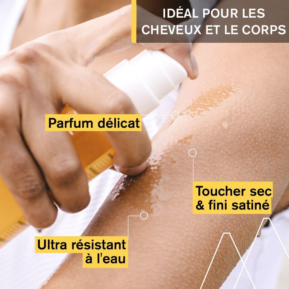 Bras avec huile sèche Uriage Bariésun appliquée. Texte : 'Parfum délicat', 'Toucher sec & fini satiné', 'Ultra résistant à l'eau'.