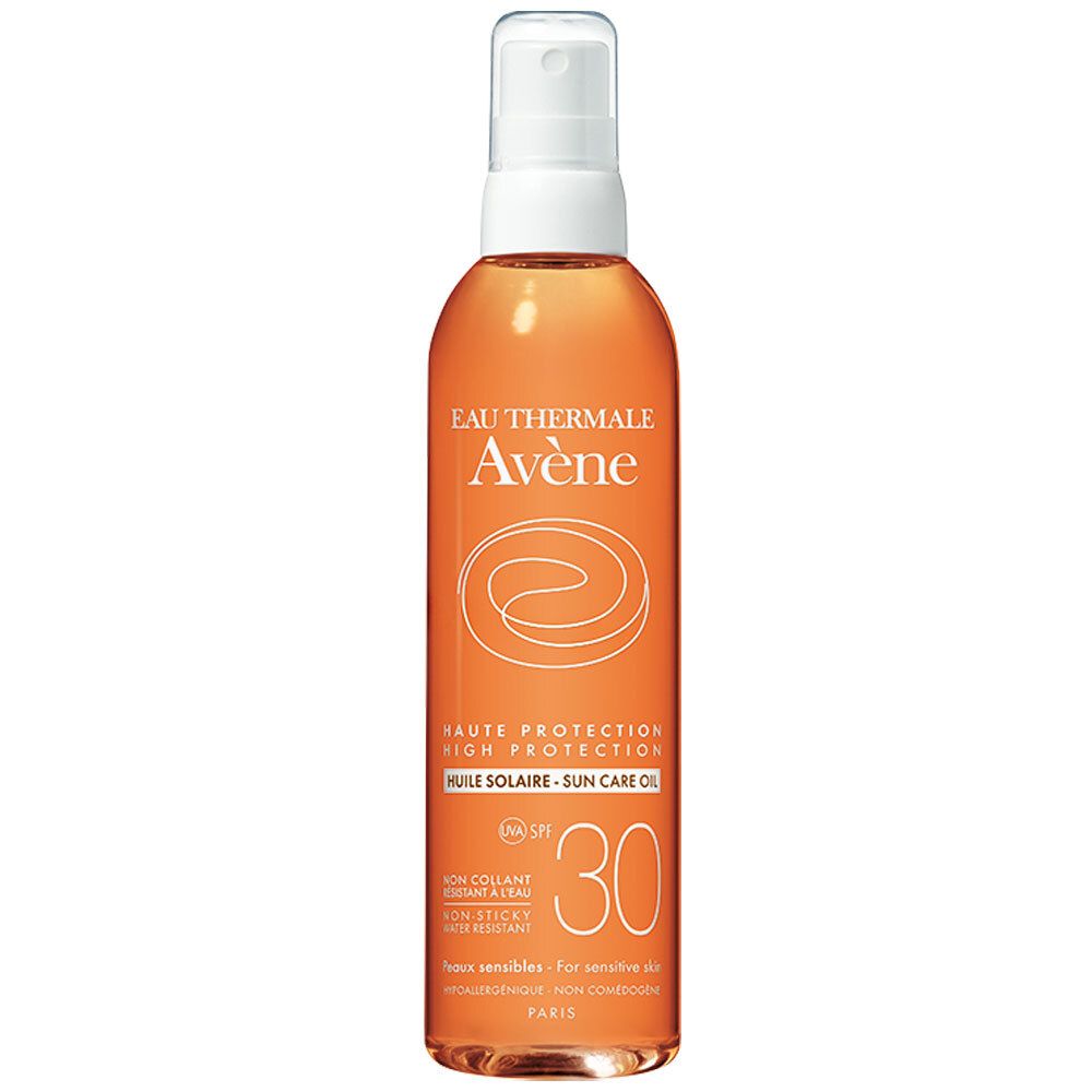 Oranje zonne-olie sprayfles, witte sproeikop. Opschrift: Eau Thermale Avène, SPF 30, Huile Solaire.