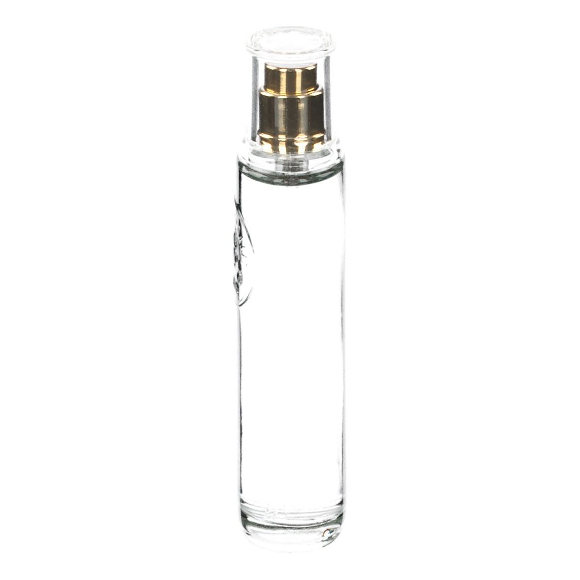 Transparante glazen fles met gouden verstuiver. Bevat heldere vloeistof. Cilindrische vorm.