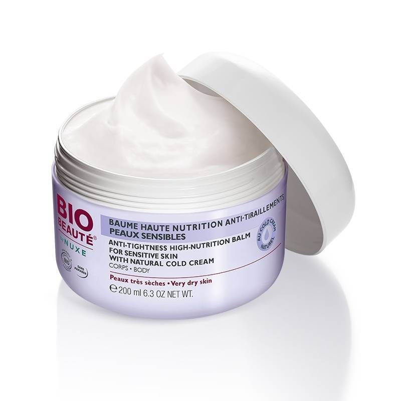 Pot de crème ouvert avec couvercle blanc. Crème visible. Inscription: BIO BEAUTÉ by NUXE. Texte: Baume Haute Nutrition, Anti-Tiraillements.