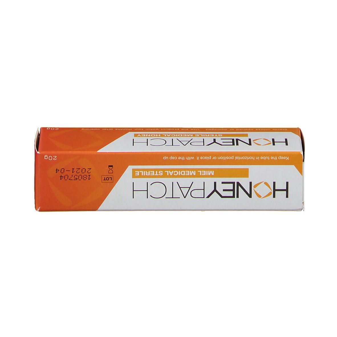 Verpakking honing. Wit-oranje ontwerp. Opschrift: Honeypatch. Steriele medische honing. 20g. Chargenummer.