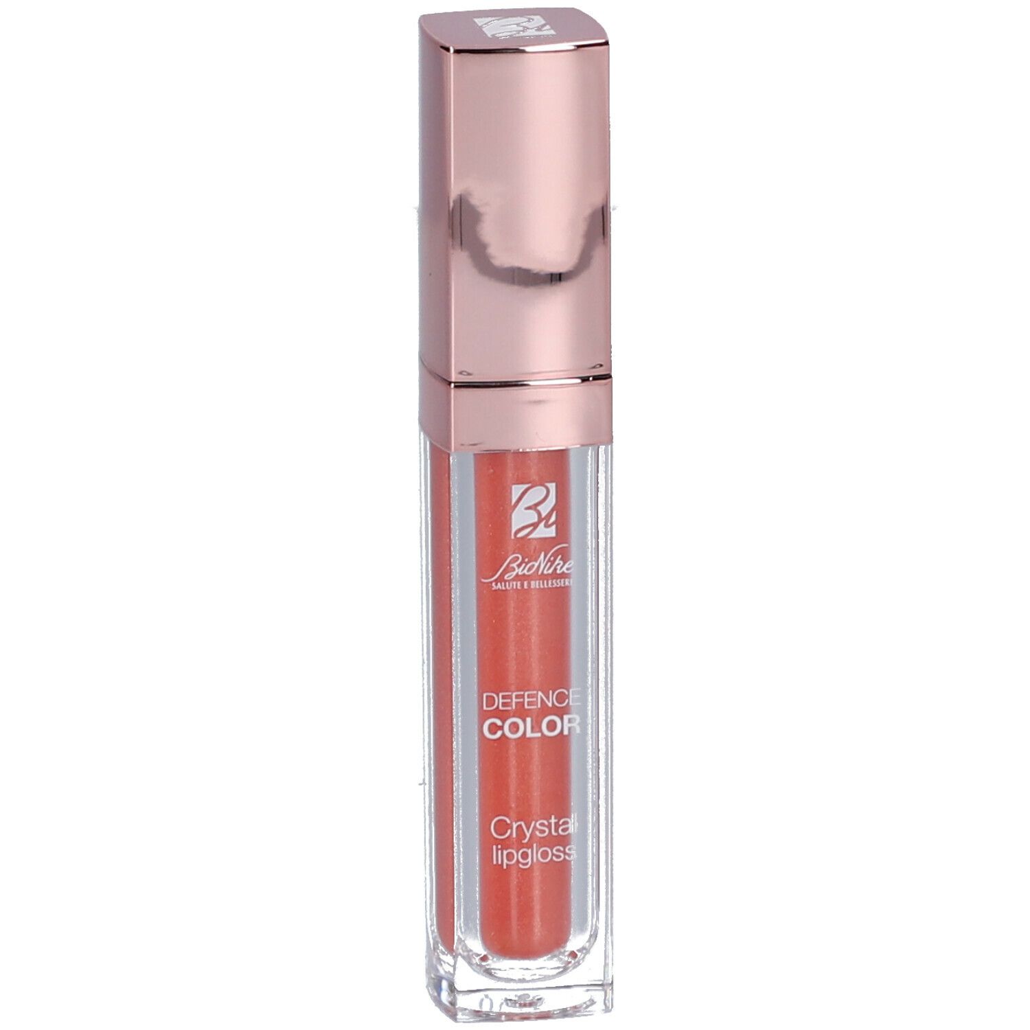 Korallenfarbener Lipgloss in einer transparenten Hülse mit roségoldfarbenem Deckel. Marke: BioNike DEFENCE COLOR.