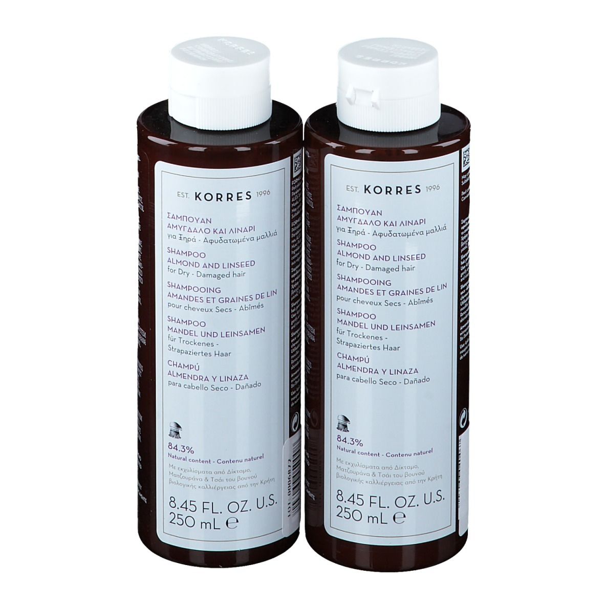 Deux flacons de shampooing bruns avec bouchons blancs. Étiquettes avec nom et contenu.