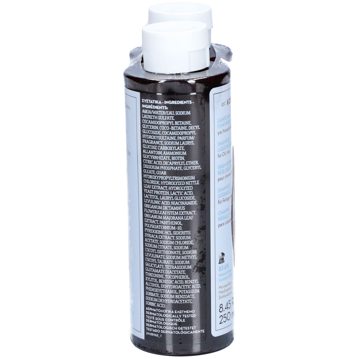 Zwei Shampoo-Flaschen, Rückansicht. Etikett mit Inhaltsstoffen und Text. Weiße Kappen. Braune Flüssigkeit. Schwarzer Hintergrund.