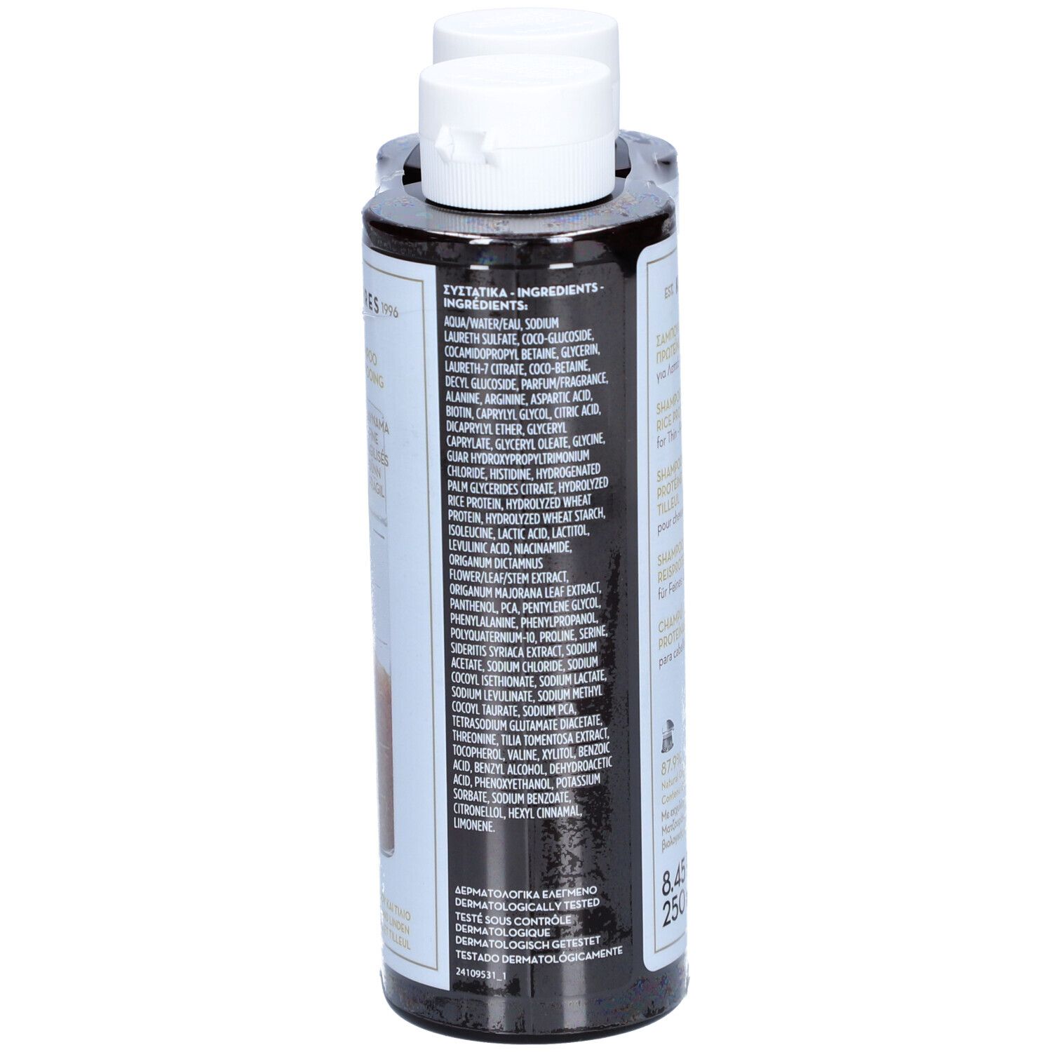 Dos d'une bouteille de shampooing. Bouteille noire avec étiquette blanche. Texte multilingue, ingrédients.