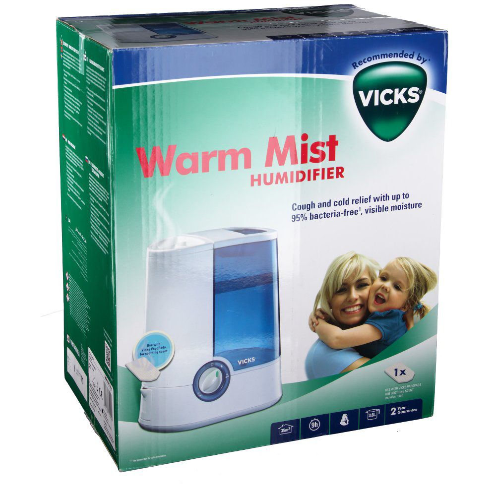 Humidificateur Vicks Warm Mist dans son emballage. Inscription: Warm Mist, logo Vicks, image d'une mère et d'un enfant.