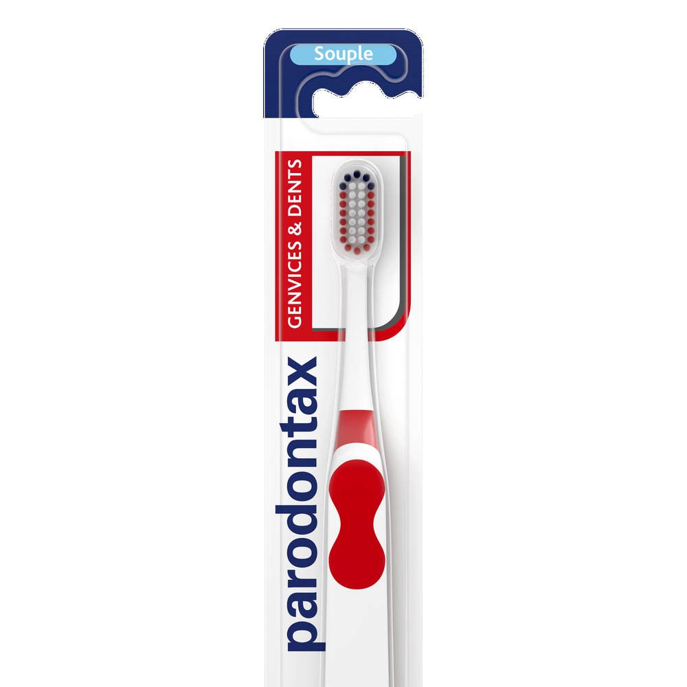Brosse à dents dans emballage. Manche blanc avec insert rouge, tête de brosse rouge. Marque: Paradontax. Texte: Gencives & dents, Souple.