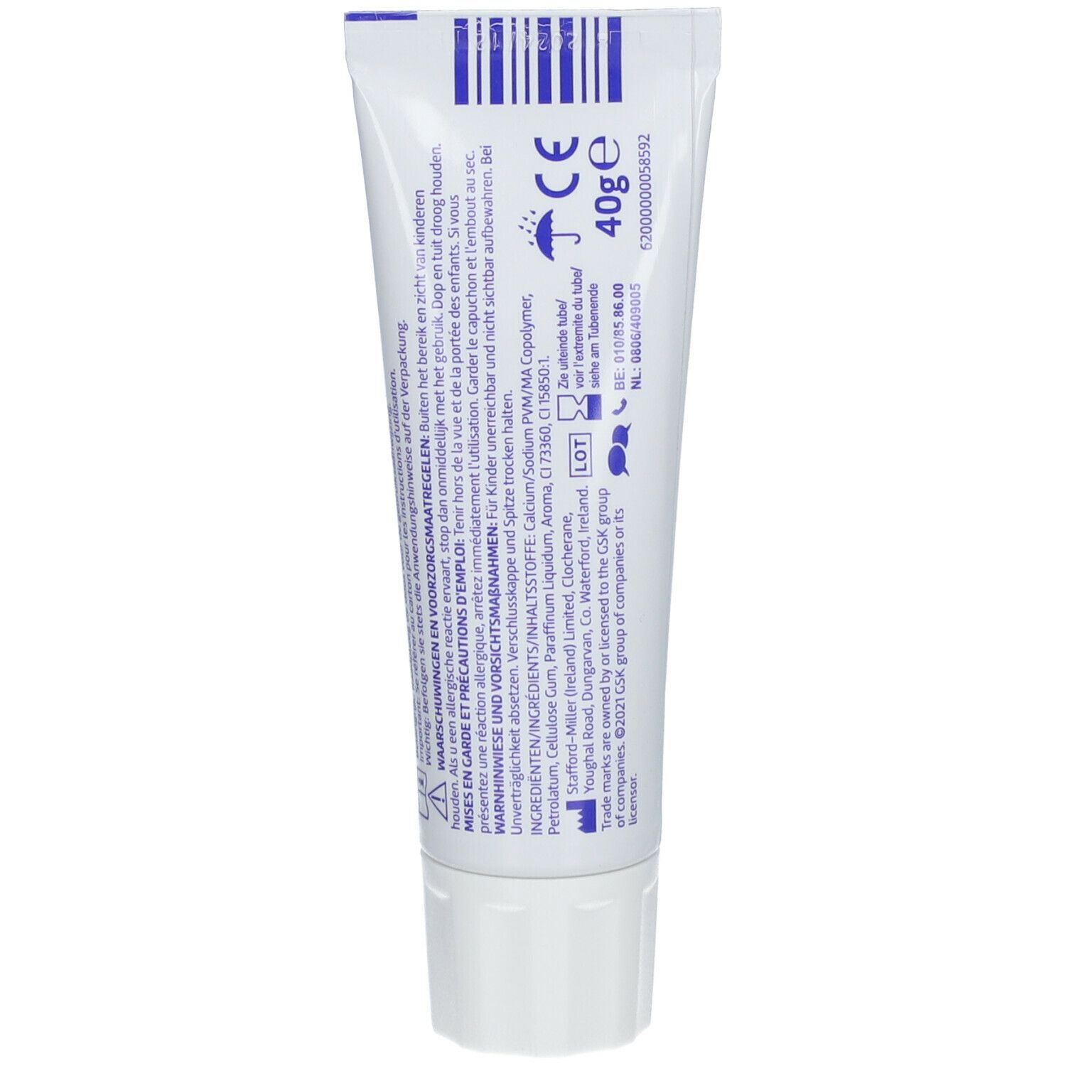 Dos du tube COREGA® Triple Action. Tube blanc avec texte et symboles. 40g.