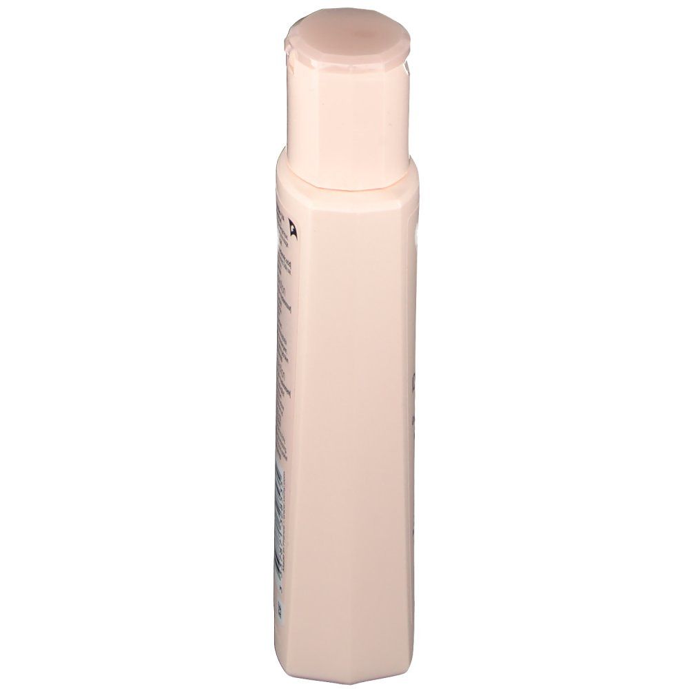 Flacon beige avec bouchon rabattable, vue latérale. Aucun autre détail visible.