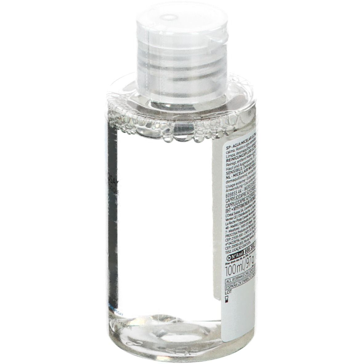 Flacon transparent avec bouchon blanc. Dos avec texte et code-barres. 100 ml.