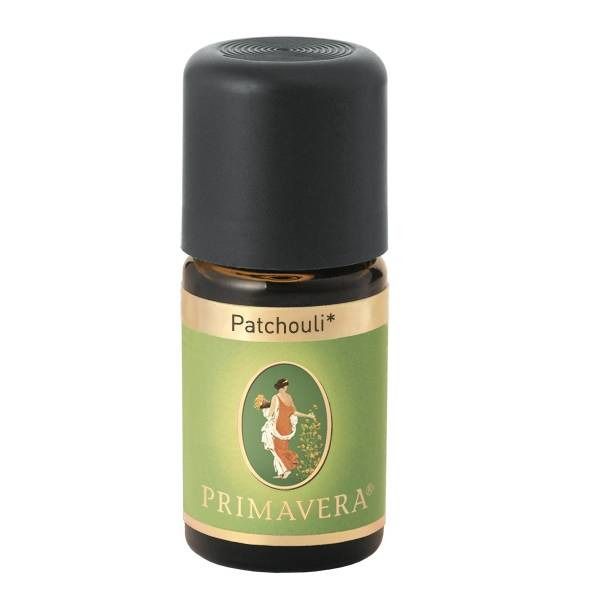Flacon en verre brun avec bouchon noir. Étiquette avec "Patchouli" et "PRIMAVERA" et une illustration d'une femme.