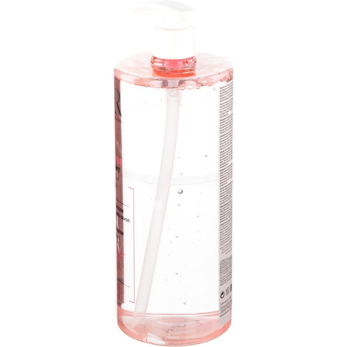Transparante fles met roze vloeistof en doseerpomp. Zijaanzicht. Lange pomp zichtbaar in de fles.
