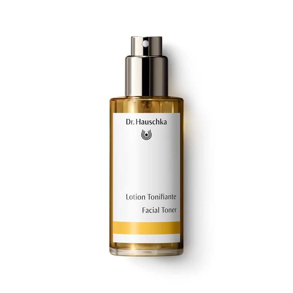 Flacon en verre contenant un liquide ambré, avec vaporisateur. Étiquette avec logo et texte 'Lotion Tonifiante Facial Toner'.
