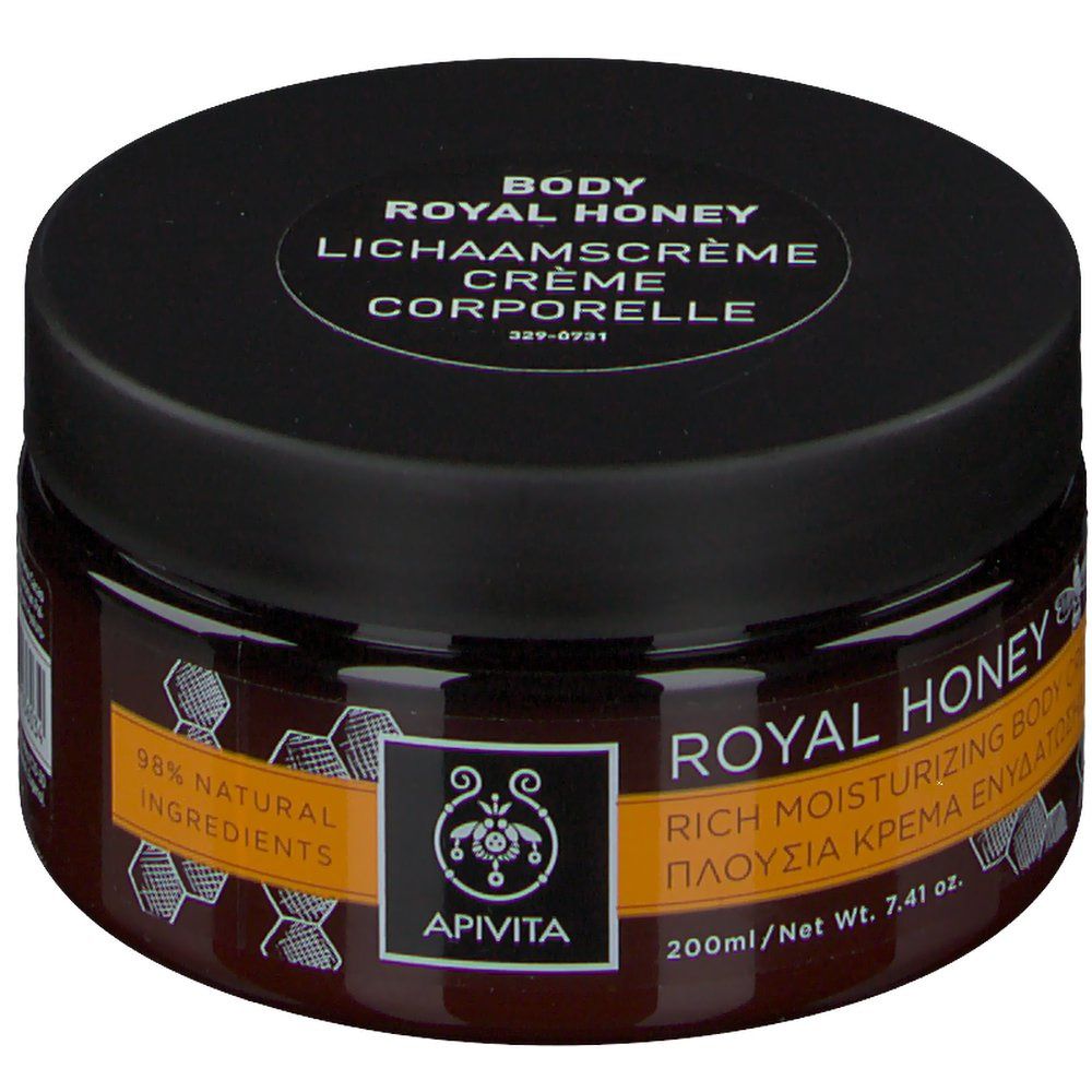 Pot rond Apivita Body Creme Hydratante Royal Honey. Couvercle noir, verre brun. Inscription: Royal Honey, 98% ingrédients naturels.