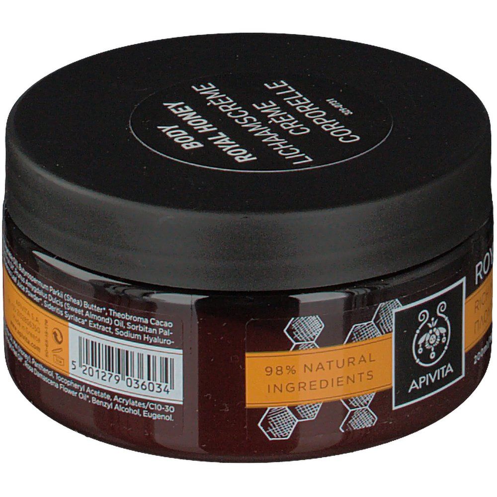 Pot rond Apivita Body Creme Hydratante Royal Honey. Couvercle noir, verre brun. Inscription: Royal Honey, 98% ingrédients naturels.