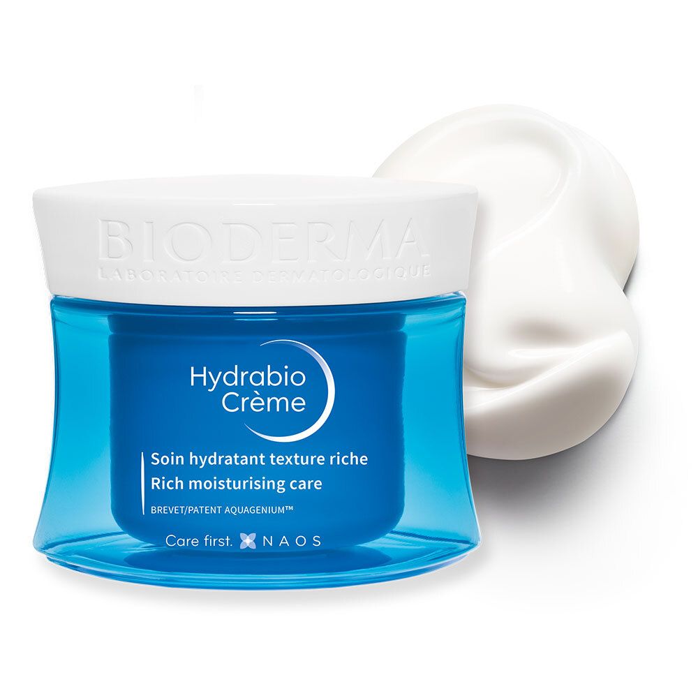 Pot de crème bleu avec couvercle blanc et crème à côté. Inscription : BIODERMA, Hydrabio Crème. Soin hydratant riche.