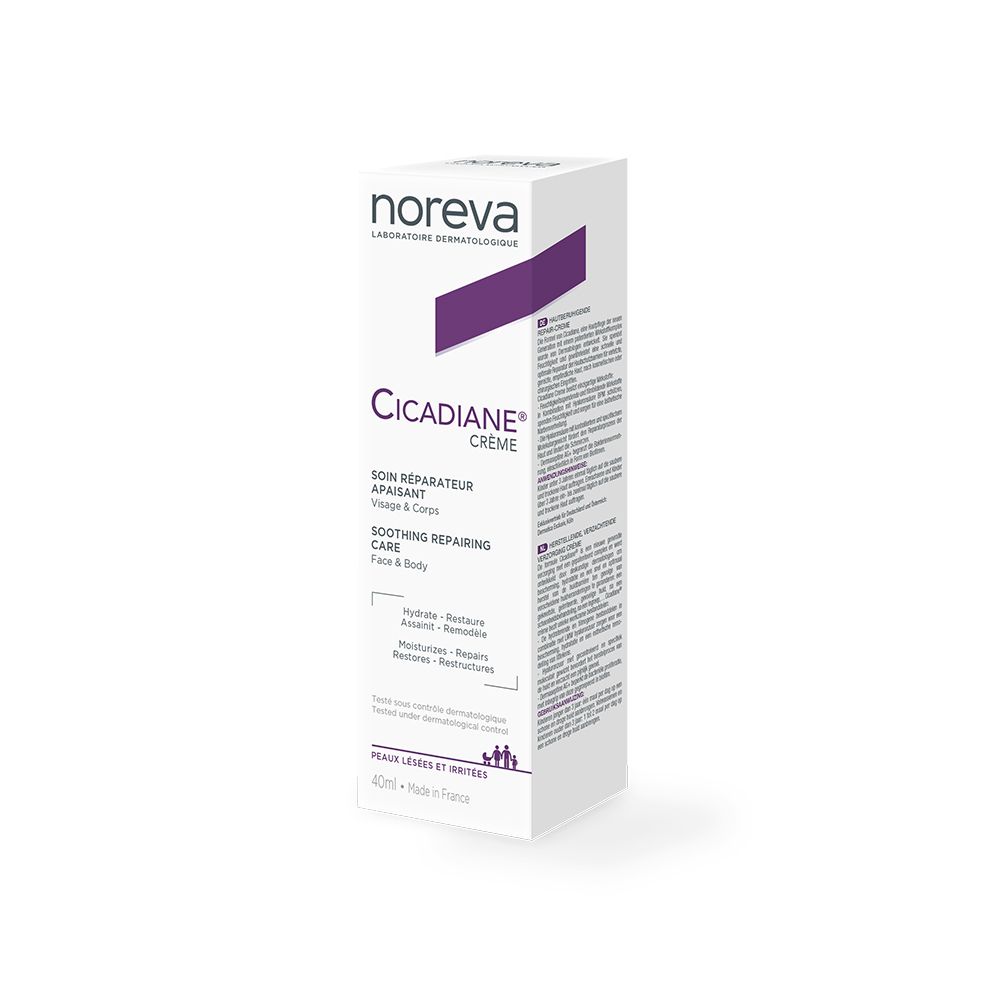 Boîte en carton blanche avec accents violets. Nom de la marque et du produit. Texte: SOIN RÉPARATEUR APAISANT. Informations produit.