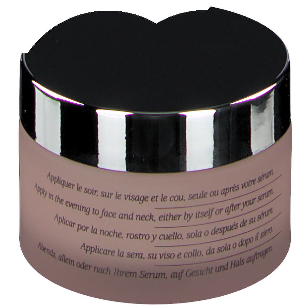 Pot de crème, vue oblique. Couvercle noir, bord argenté. Texte: Apply in the evening to face and neck, either by itself or after serum.