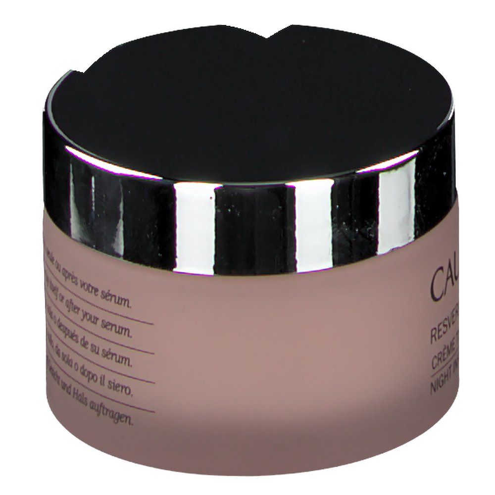 Pot de crème, vue oblique. Couvercle noir, bord argenté. Texte: Apply in the evening to face and neck, either by itself or after serum.