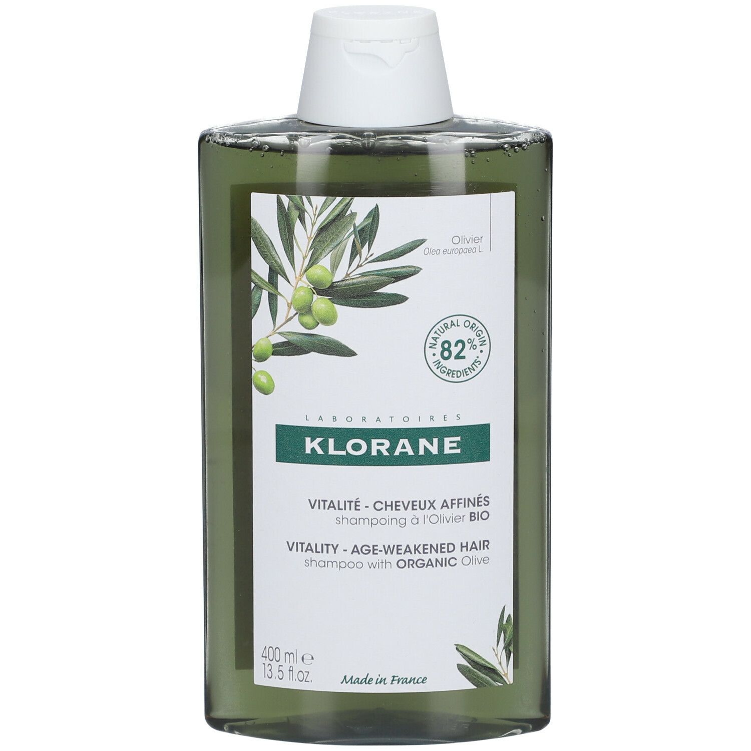 Flacone di shampoo verde con tappo bianco. Etichetta con illustrazione di olive e testo: KLORANE, Vitalité, 82% ingredienti di origine naturale.