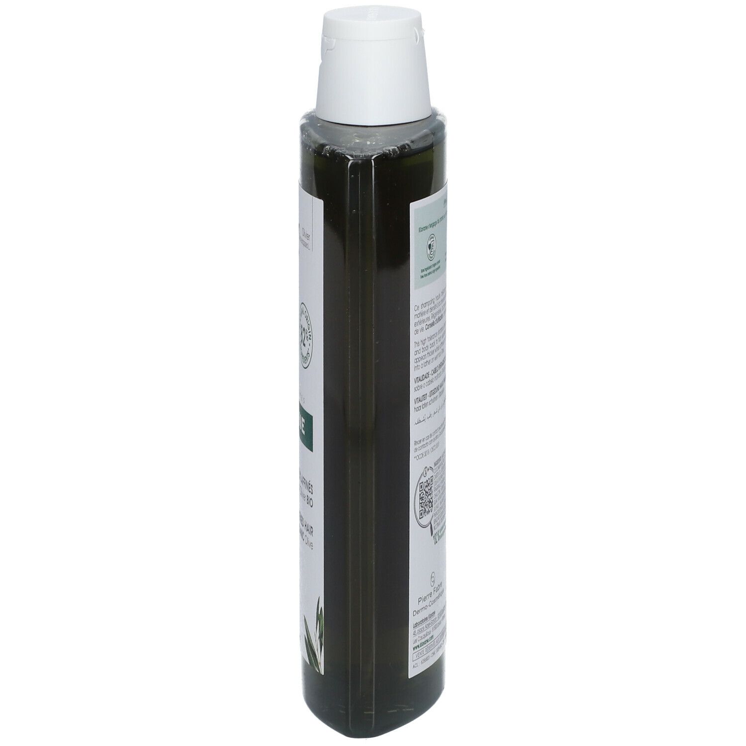 Vista stretta di un flacone di shampoo verde con tappo bianco. Etichetta con testo.