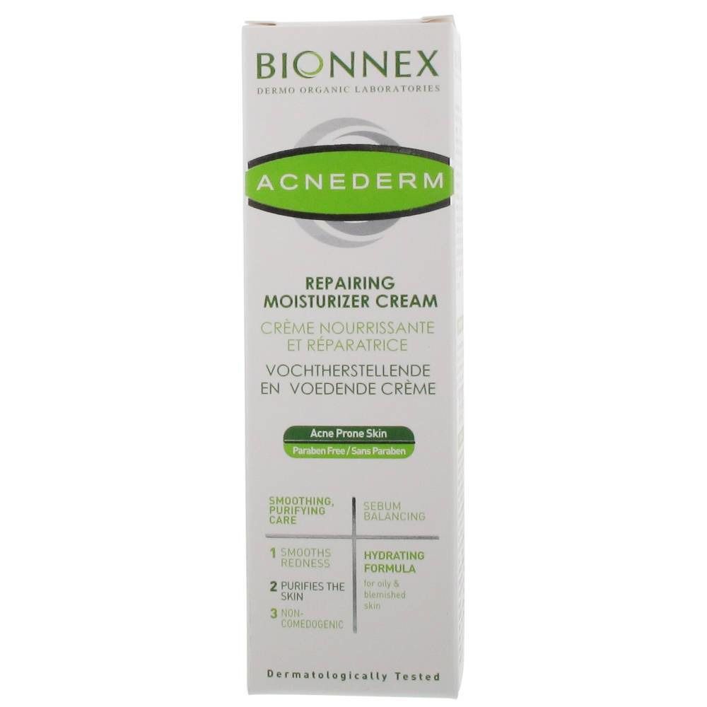 Boîte blanche avec nom et description du produit. Texte : "ACNEDERM Repairing Moisturizer Cream". Pour peaux à problèmes. Testé dermatologiquement.