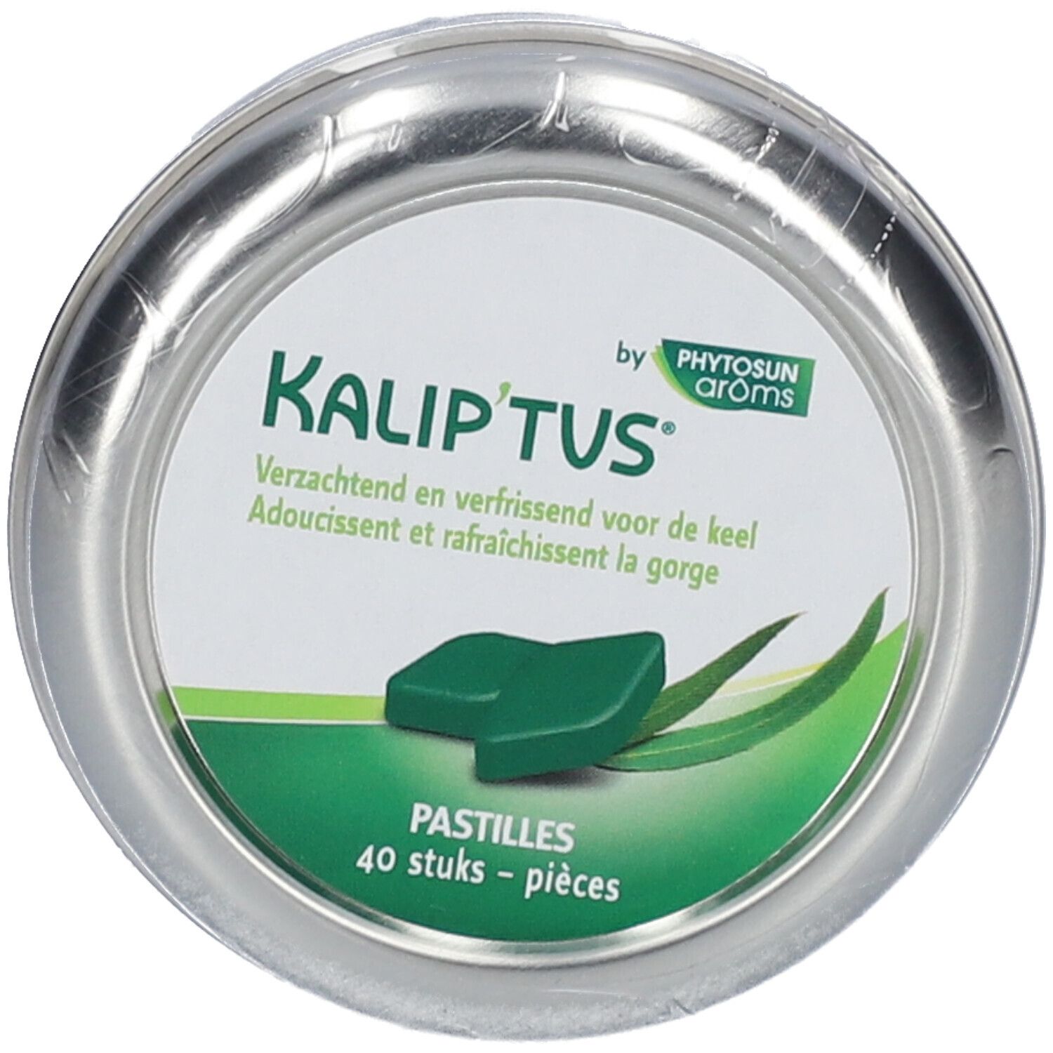 Boîte ronde de pastilles. Étiquette verte et blanche avec nom du produit et informations. Une pastille au centre.