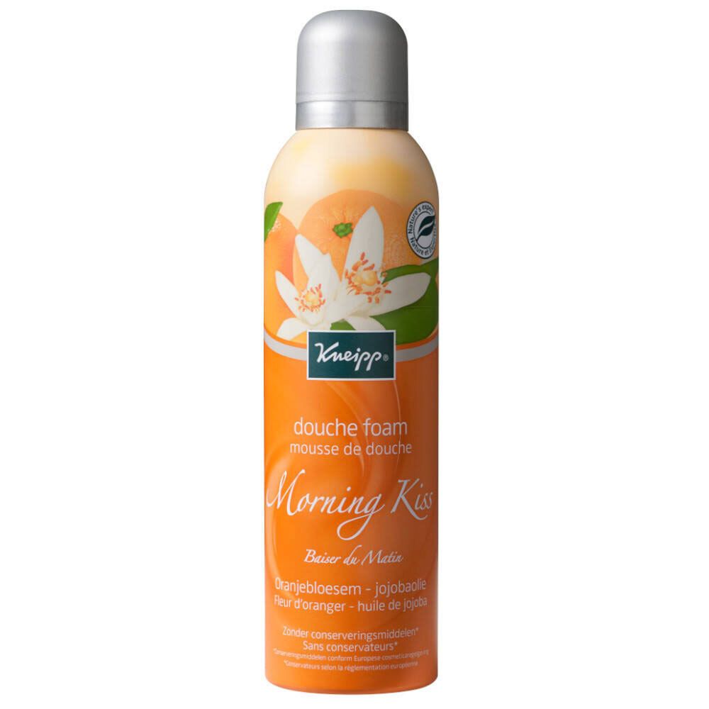 Flacon de mousse de douche avec bouchon argenté. Étiquette orange avec fleurs, orange et texte.