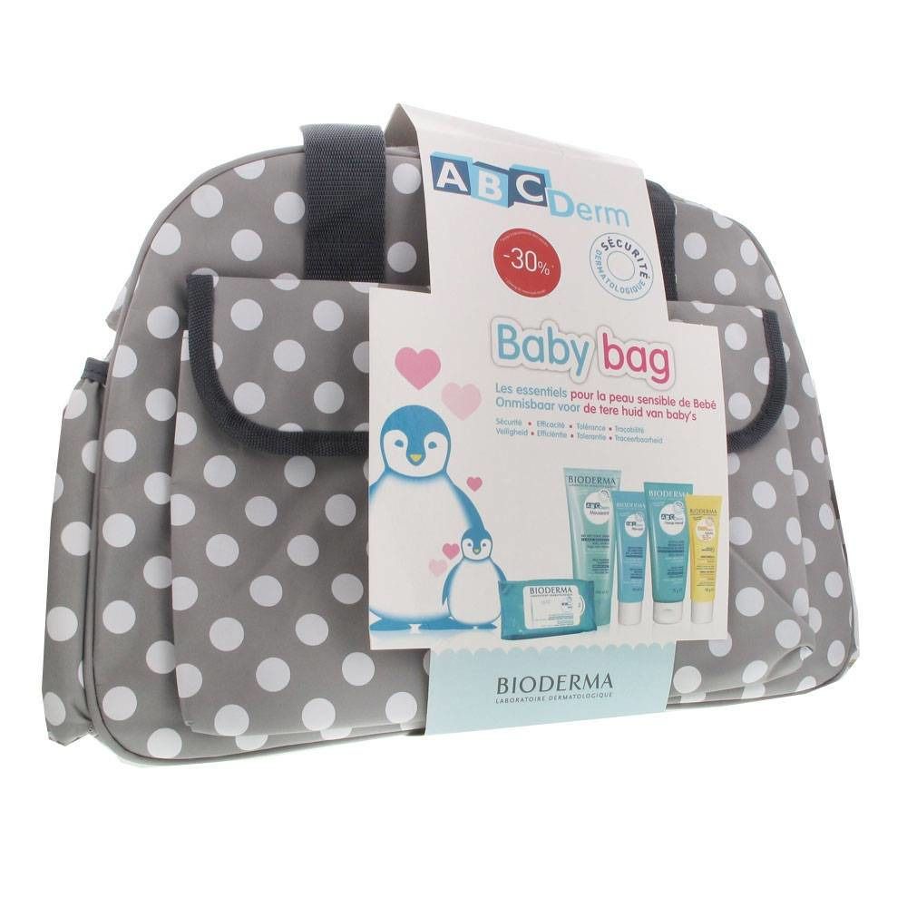 Sac à langer gris à pois blancs. Étiquette "ABC Derm Baby bag" et réduction. Illustrations de pingouins.