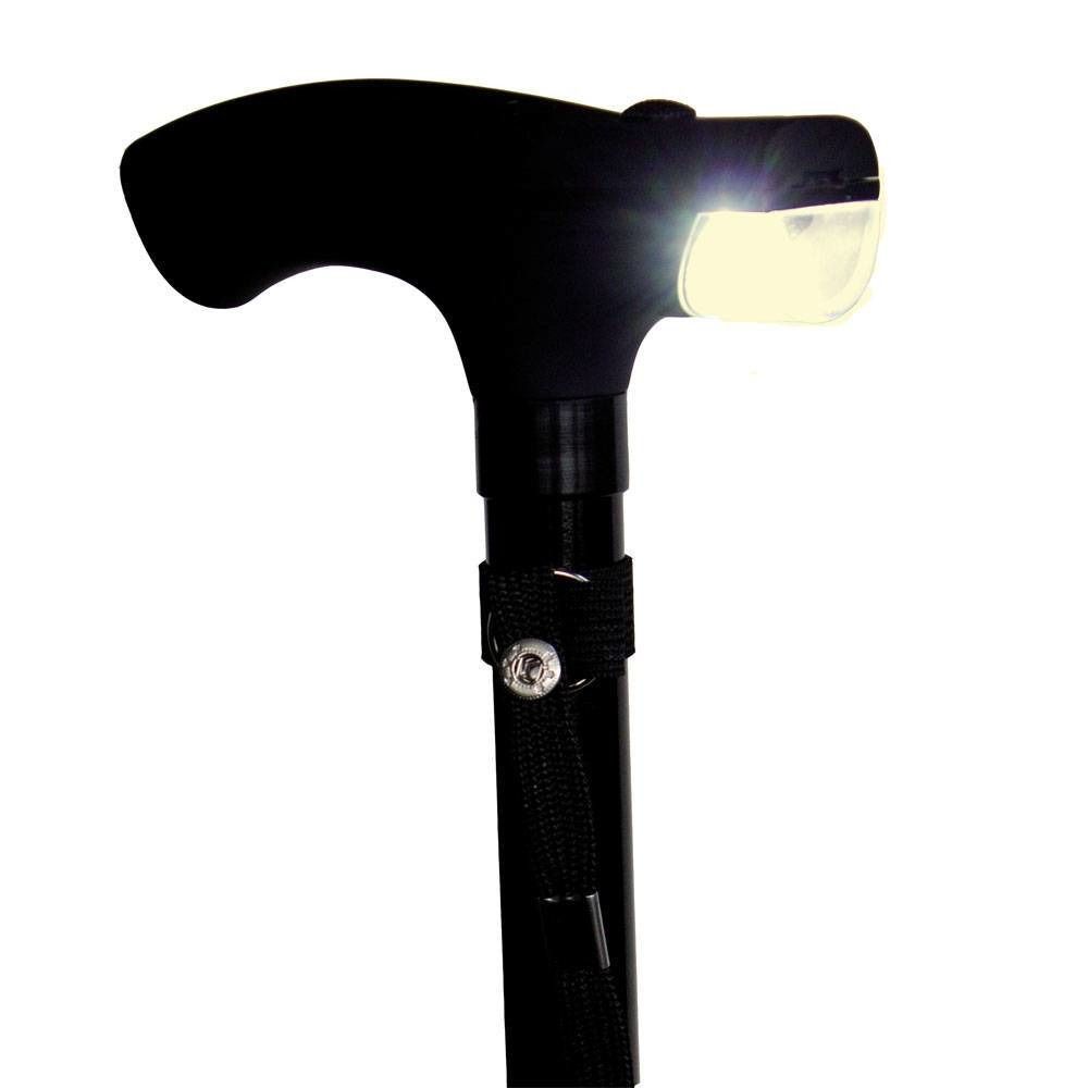 Gros plan sur la poignée en T noire d'une canne. Lampe LED intégrée. Dragonne.