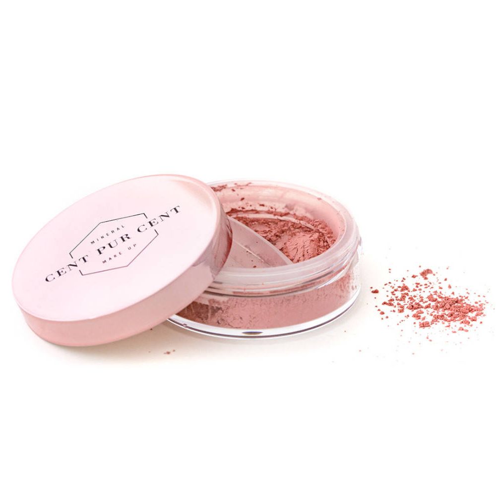Récipient de poudre rose lâche, couvercle à côté. Logo sur le couvercle.