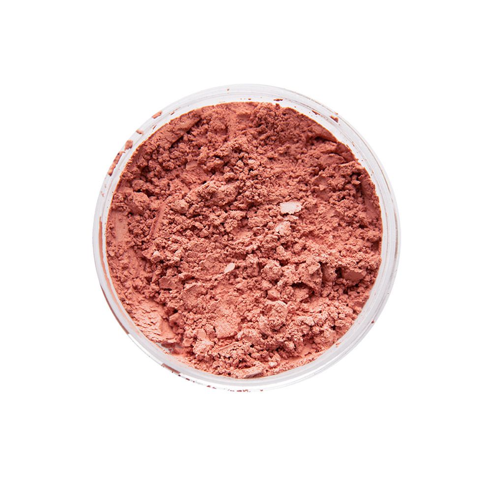 Récipient rond de poudre rose lâche. Vue de dessus.