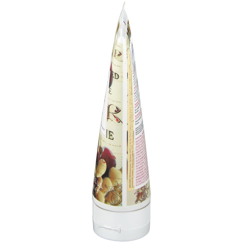 Seitenansicht der Körperlotion-Tube. Weiße Kappe, spitz zulaufende Form. Bedruckt mit Mandel- und Kirsch-Motiven.