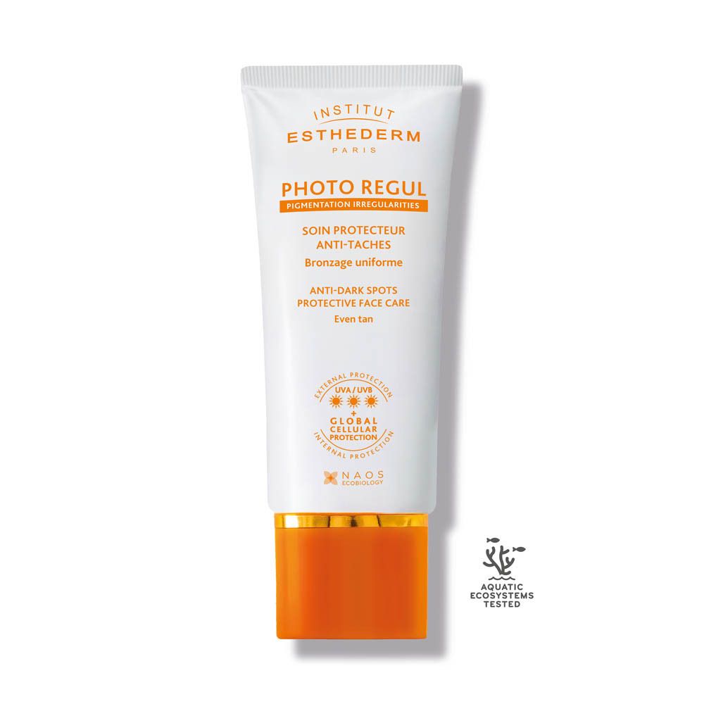 Tube blanc-orange avec nom du produit et texte. Protection solaire pour pigmentation irrégulière.